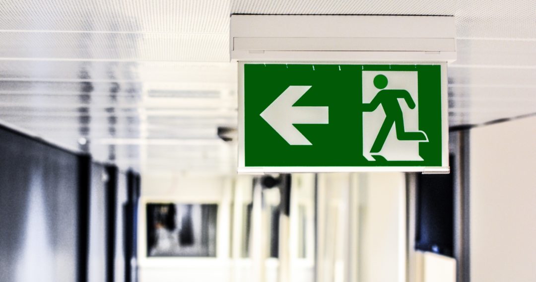 Photograph of a fire exit sign on the ceiling